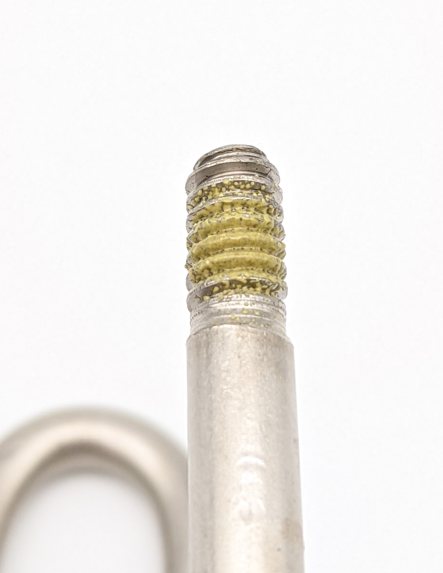 Wire form with pre-apply inert threadlocking patch