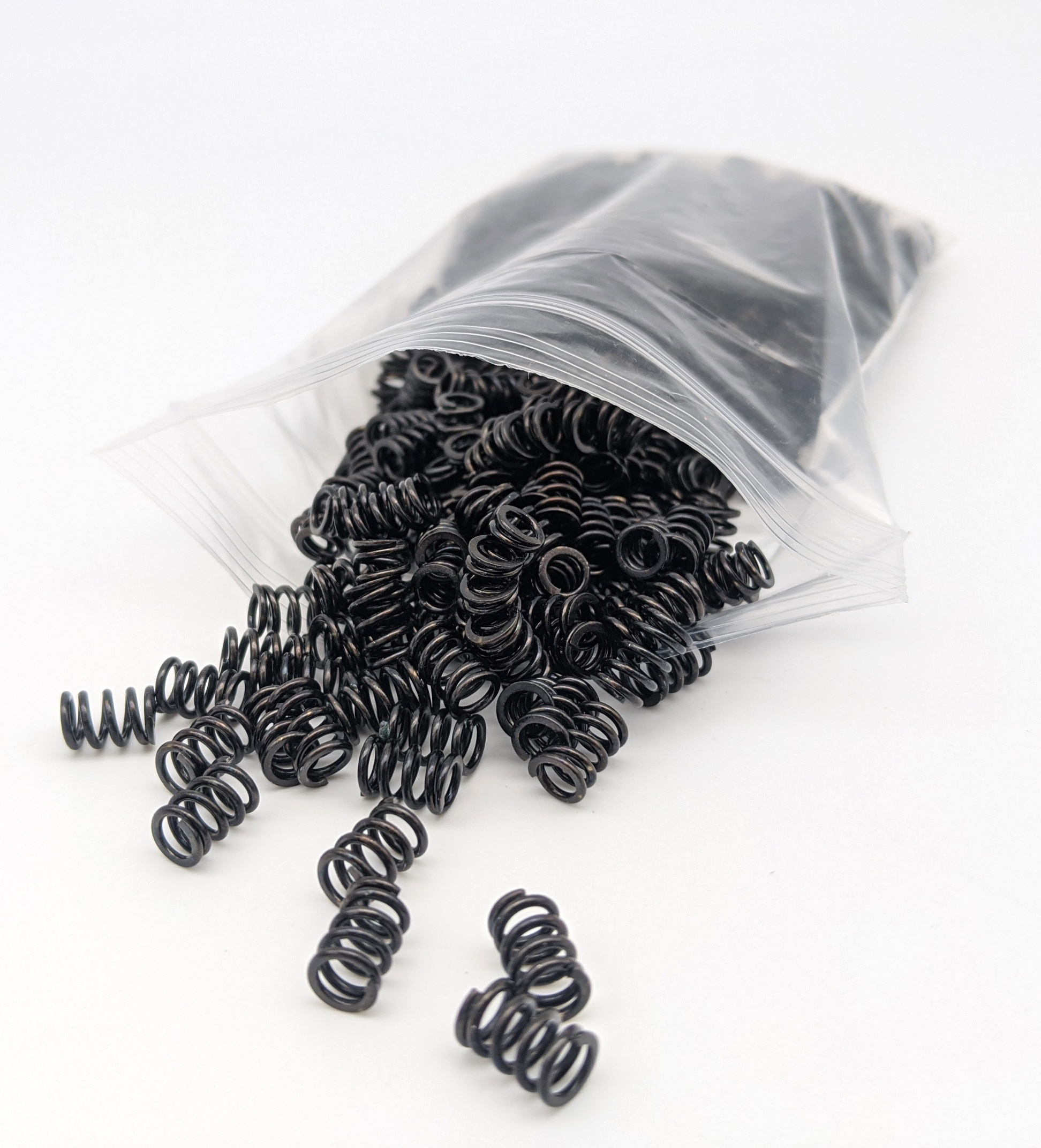 A small bag of custom coil springs with black finish